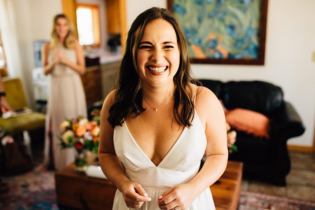 Bride in her wedding dress smiling at the camera