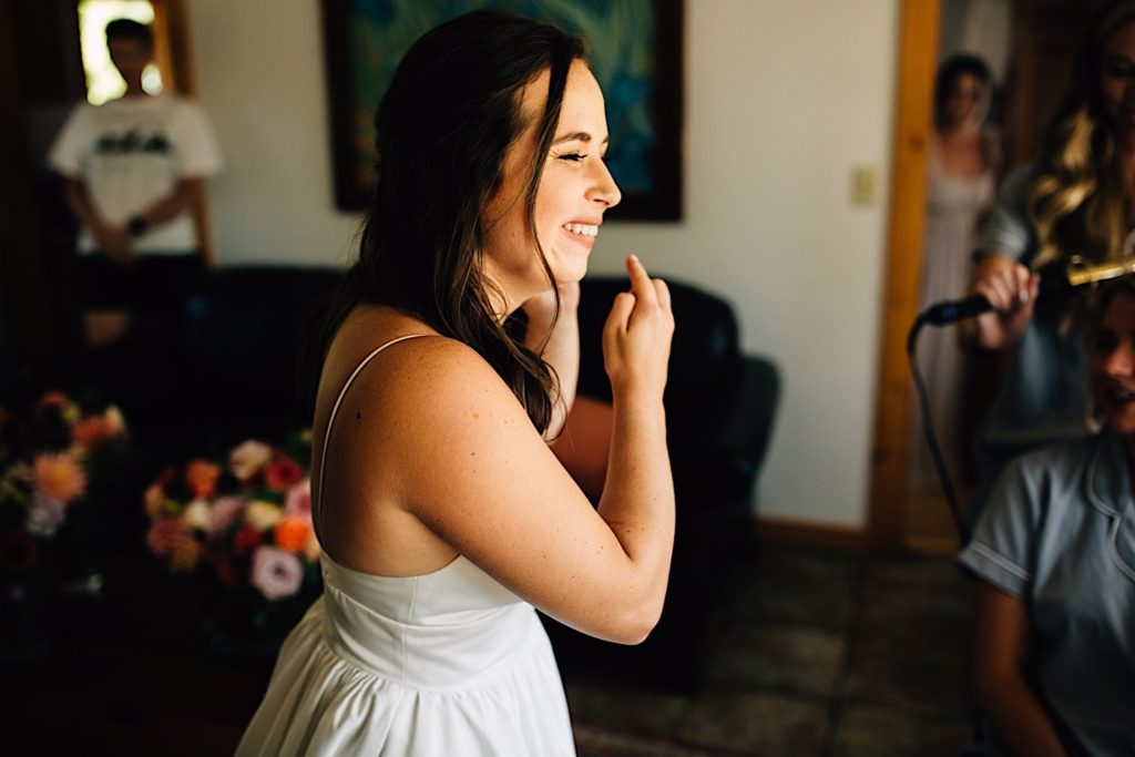 Bride adjusting her earing and smiling