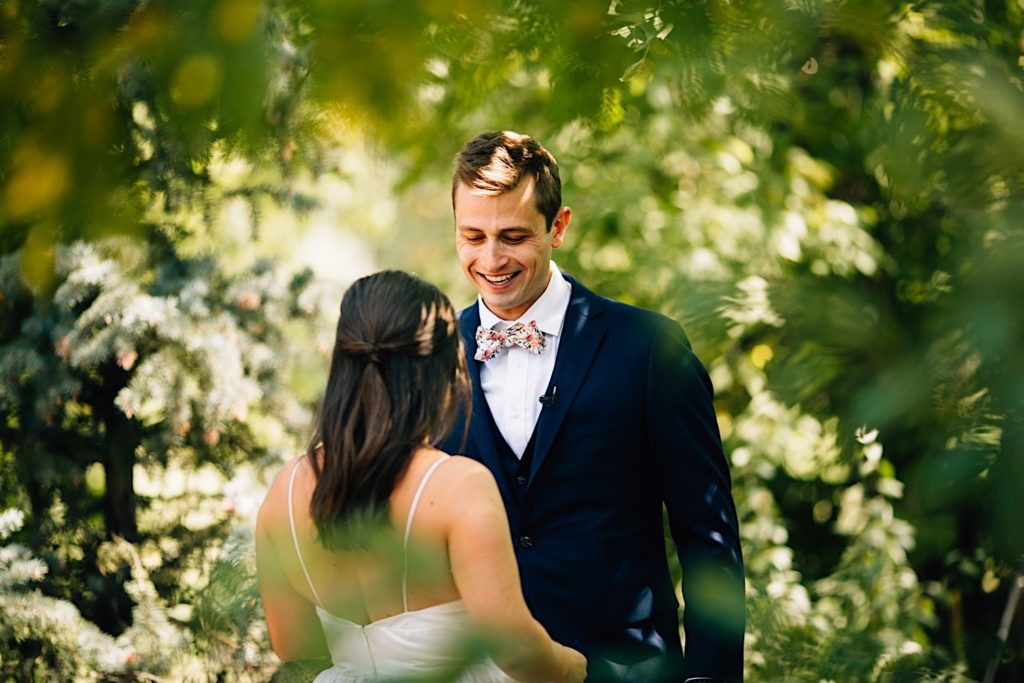 Groom smiles while looking at his bride 