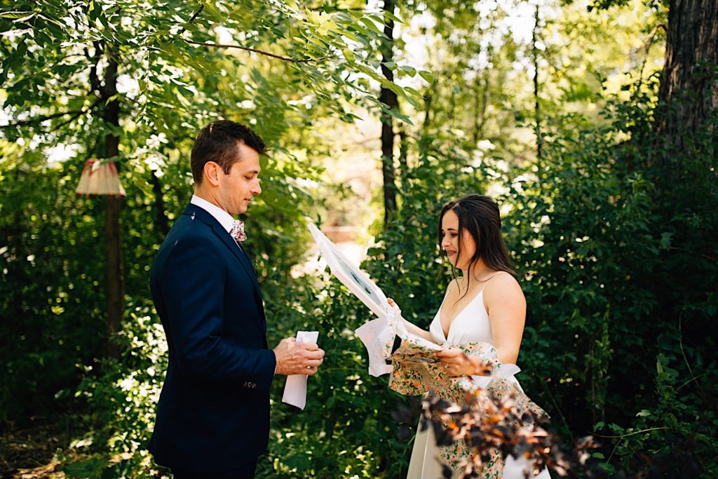 Bride tears up holding a gift from the groom before their wedding