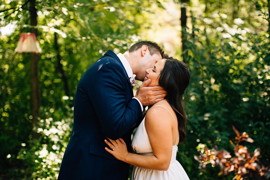 Groom kisses bride on the cheek