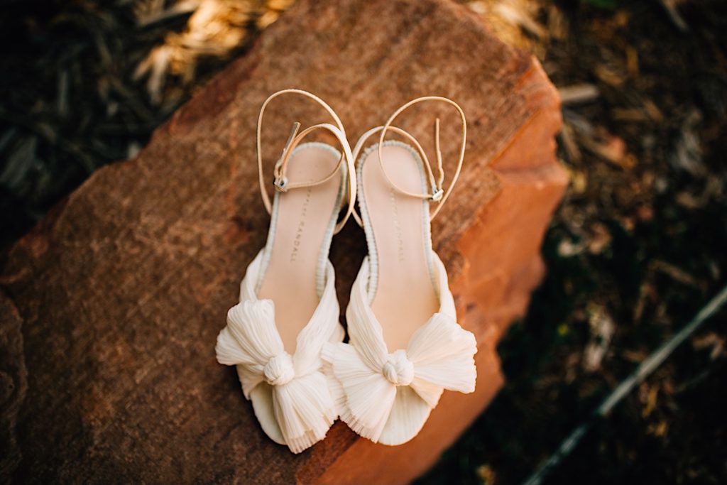 Women's wedding shoes placed on a stone