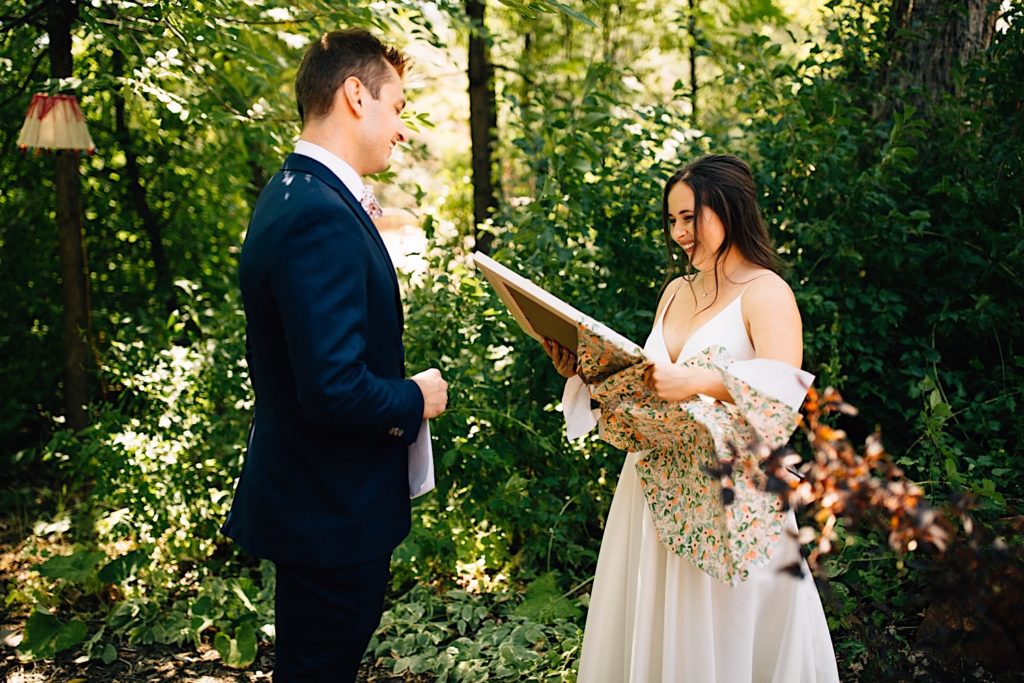 Bride and groom smile as they exchange wedding gifts
