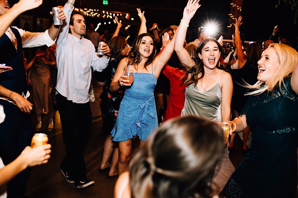 Wedding guests celebrate and dance during wedding reception